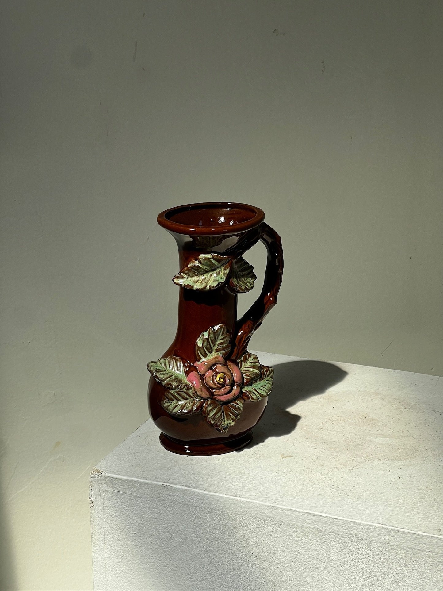 Small antique ceramic vase with 3D floral motifs