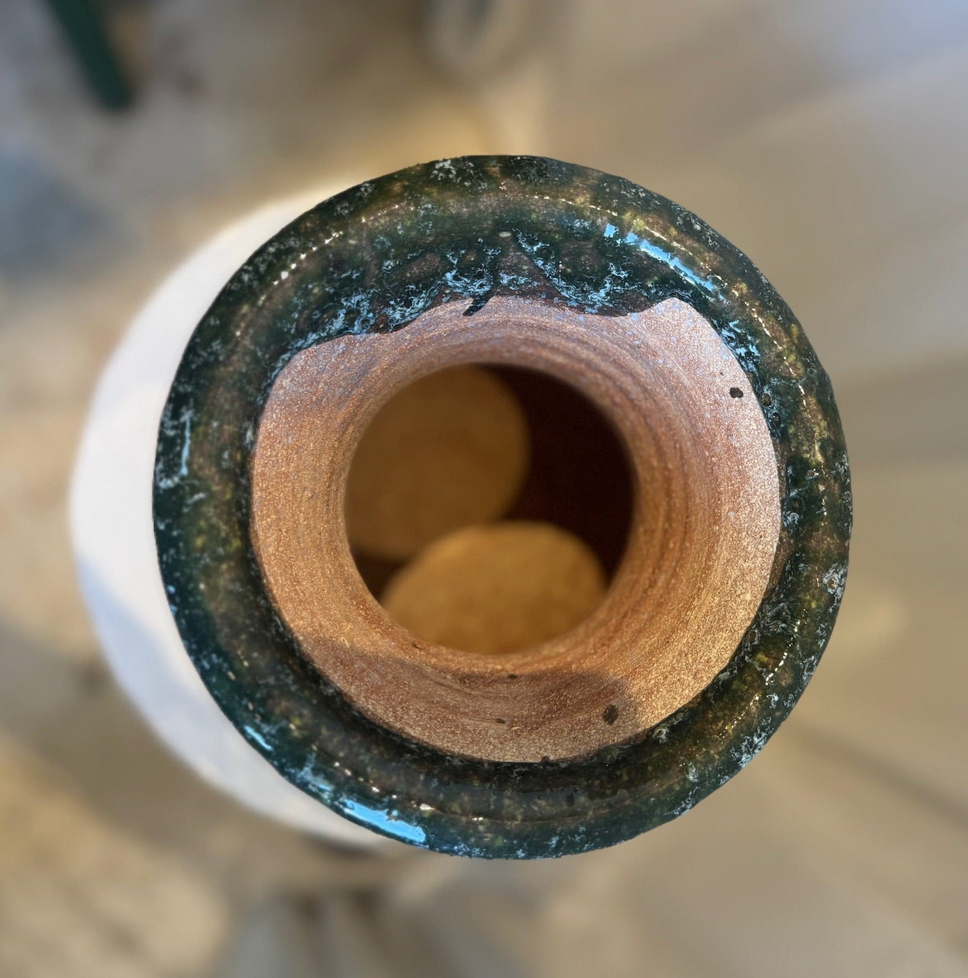 Amphora-style vase with rounded handles and wide rim, featuring aged green drip glaze over natural terracotta — Hommes and Gardens, Mediterranean Collection, landscape design, plant design, Landscape Architect, Interior Designer, Outdoor Living, Outdoor Decorations, Home Design, Luxury Design, Art, Furniture, Objects, Best Gifts, Nature, Backyard, Yard.