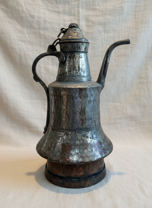 Antique hand-hammered Middle Eastern Dallah coffee pot crafted from copper and tin with arched handle, curved spout, and aged patina, a traditional Arabic serving vessel — Hommes and Gardens, Objects Collection, Home Decor, Landscape Architect, Interior Designer, Outdoor Living, Outdoor Decorations, Home Design, Luxury Design, Art, Furniture, Objects, Best Gifts, Nature, Backyard, Yard.