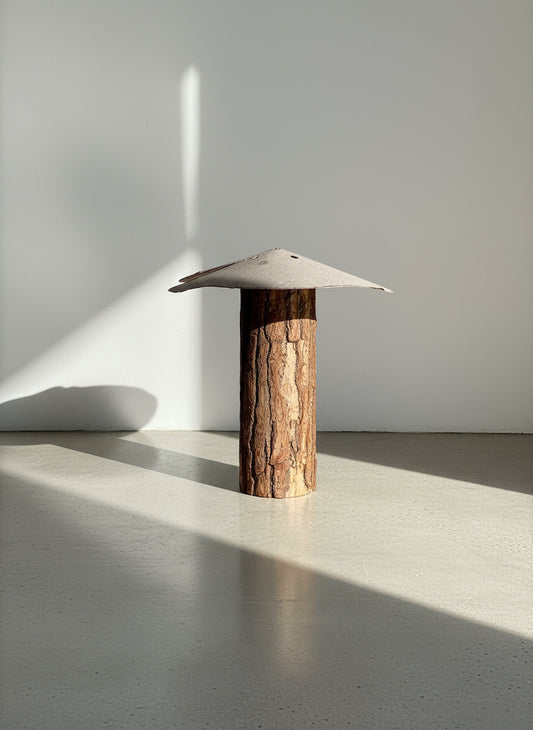 Bark-wood mushroom sculpture with a gray metal roof, handcrafted from a bark-covered wooden post showcasing rustic primitive folk art design and reclaimed natural textures — Hommes and Gardens, Home Decor Collection, landscape design, plant design, Landscape Architect, Interior Designer, Outdoor Living, Outdoor Decorations, Home Design, Luxury Design, Art, Furniture, Objects, Best Gifts, Nature, Backyard, Yard.