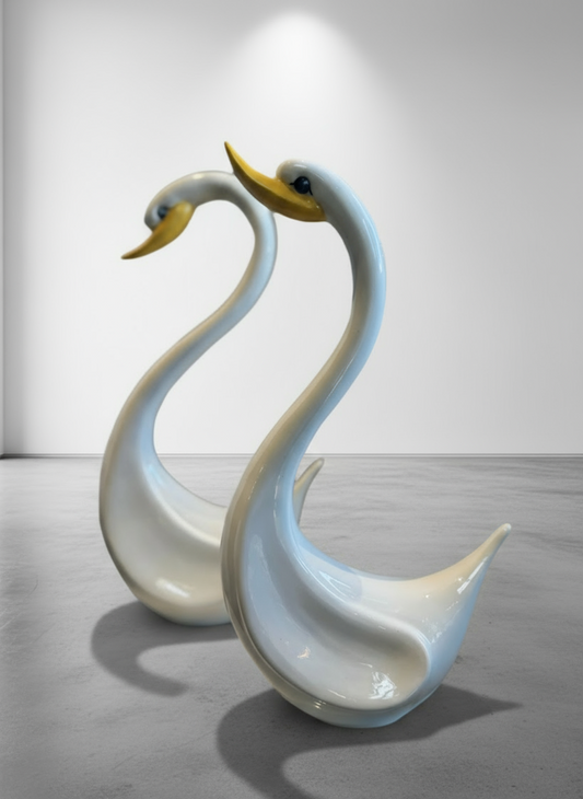 Pair of elegant vintage ceramic swan sculptures in glossy white with yellow beaks, mid-century modern style — Hommes and Gardens, Home Decor Collection, landscape design, plant design, Landscape Architect, Interior Designer, Outdoor Living, Outdoor Decorations, Home Design, Luxury Design, Art, Furniture, Objects, Best Gifts, Nature, Backyard, Yard.