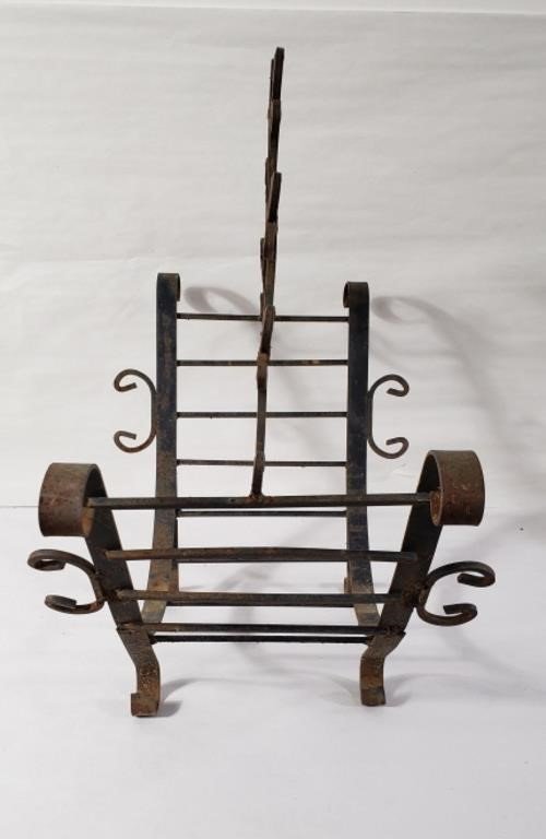 Classic wrought iron firewood holder with elegant curves and vintage patina, designed for both decorative appeal and functional firewood storage — Hommes and Gardens, Home Decor Collection, Firewood Holders, Decorative Objects, Rustic Iron Decor, Antique Fireplace Accessory, Vintage Metalwork, Traditional Home Accent, Hearth Organizer.