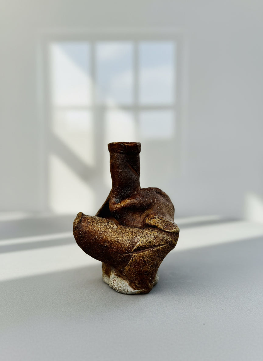 Side view of freeform organic studio pottery vase in sculptural stoneware with abstract modernist design and earthy glaze tones — Hommes and Gardens, Home Decor Collection, landscape design, plant design, Landscape Architect, Interior Designer, Outdoor Living, Outdoor Decorations, Home Design, Luxury Design, Art, Furniture, Objects, Best Gifts, Nature, Backyard, Yard.