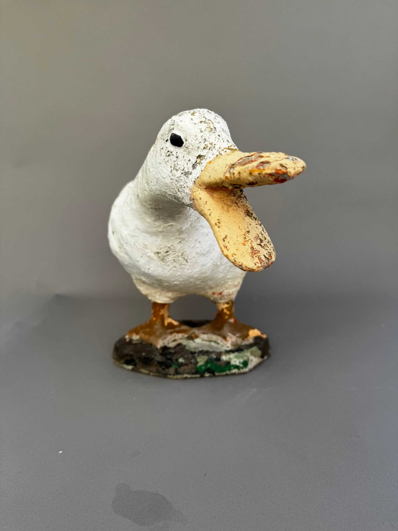 Front view of vintage concrete goose doorstop sculpture with hand-painted details and expressive quacking pose — Hommes and Gardens, Home Decor Collection, landscape design, plant design, Landscape Architect, Interior Designer, Outdoor Living, Outdoor Decorations, Home Design, Luxury Design, Art, Furniture, Objects, Best Gifts, Nature, Backyard, Yard.