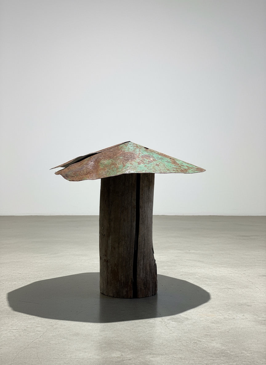 Green-patina mushroom sculpture handcrafted from a weathered log stem with an aged metal cap, showcasing rustic primitive folk art and reclaimed garden design — Hommes and Gardens, Home Decor Collection, landscape design, plant design, Landscape Architect, Interior Designer, Outdoor Living, Outdoor Decorations, Home Design, Luxury Design, Art, Furniture, Objects, Best Gifts, Nature, Backyard, Yard.