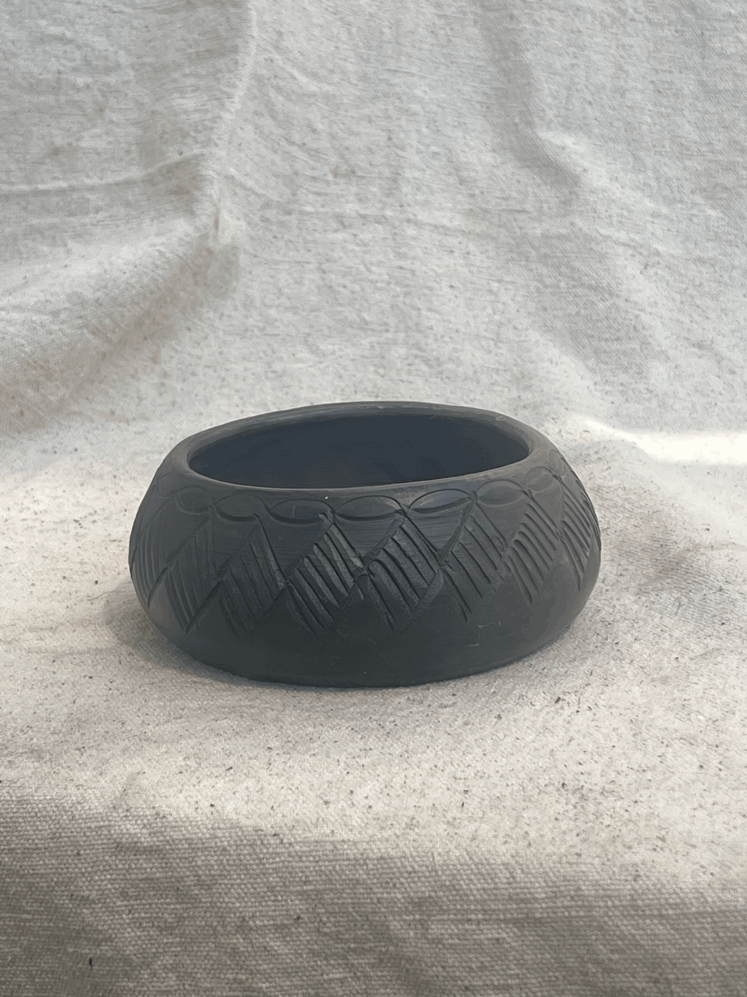 Handmade Cherokee pottery vessel by S. Bigmeat, crafted in black clay with traditional patterns, representing authentic Native American artistry — Hommes and Gardens, Pots and Vessels Collection, Vases, Art Pottery, Decorative Objects, Vintage Pottery, Indigenous Craftsmanship, Cultural Heritage, Collectible Ceramic Art.
