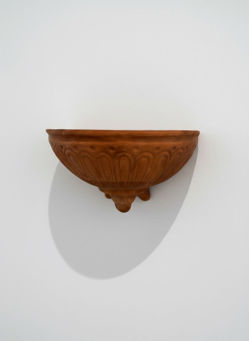 Vintage Italian terracotta wall pocket planter with handcrafted fluted design and natural weathered patina, front view — Hommes and Gardens, Pots + Vessels Collection, landscape design, plant design, Landscape Architect, Interior Designer, Outdoor Living, Outdoor Decorations, Home Design, Luxury Design, Art, Furniture, Objects, Best Gifts, Nature, Backyard, Yard.