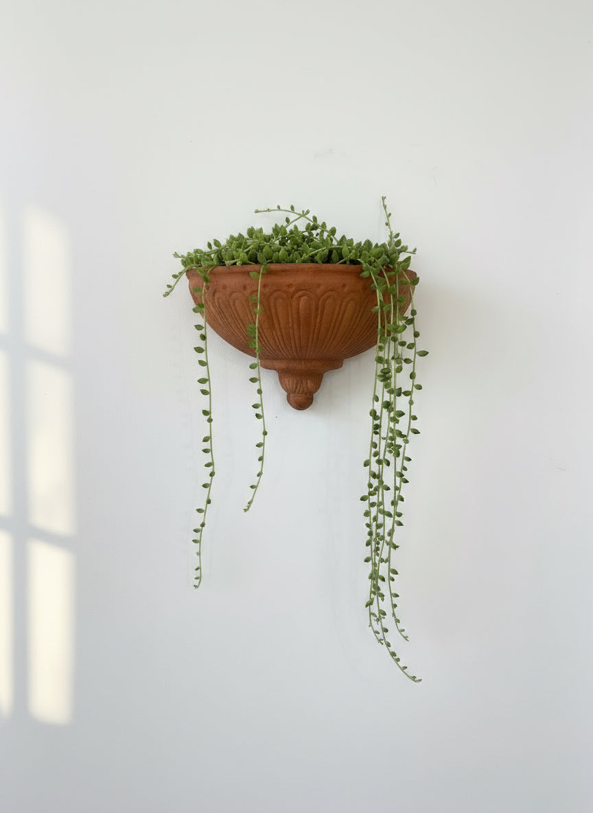 Vintage Italian terracotta wall pocket planter with handcrafted fluted design and weathered finish, side angle — Hommes and Gardens, Pots + Vessels Collection, landscape design, plant design, Landscape Architect, Interior Designer, Outdoor Living, Outdoor Decorations, Home Design, Luxury Design, Art, Furniture, Objects, Best Gifts, Nature, Backyard, Yard.