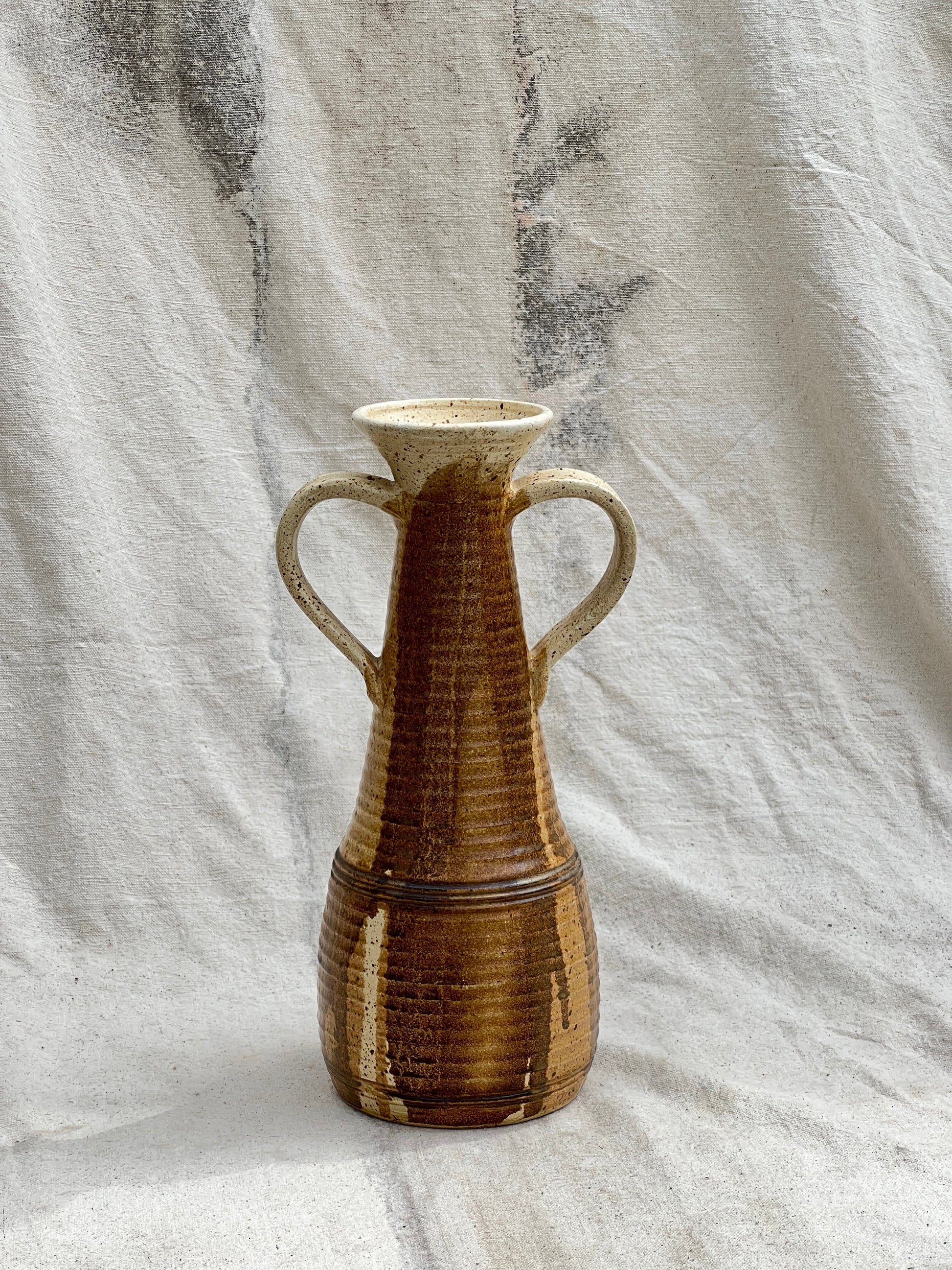 MCM handmade ceramic vase with handles, signed and dated 1984, featuring earthy brown glaze and sculptural mid-century form — Hommes and Gardens, Pots + Vessels Collection, Landscape Architect, Interior Designer, Outdoor Living, Outdoor Decorations, Home Decor, Home Design, Luxury Design, Art, Furniture, Objects, Best Gifts, Nature, Backyard, Yard.