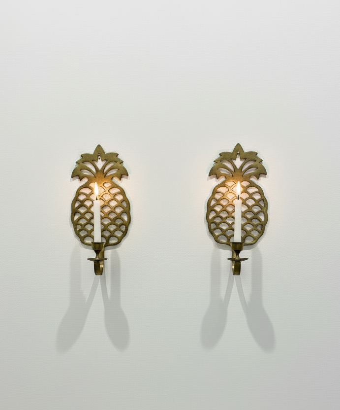 Pair of vintage brass pineapple wall candle sconces with intricate openwork detailing and golden patina, a timeless decorative set symbolising warmth and hospitality — Hommes and Gardens, Wallscape Collection, Smoke + Fire Collection, Home Decor, Landscape Architect, Interior Designer, Outdoor Living, Outdoor Decorations, Home Design, Luxury Design, Art, Furniture, Objects, Best Gifts, Nature, Backyard, Yard.