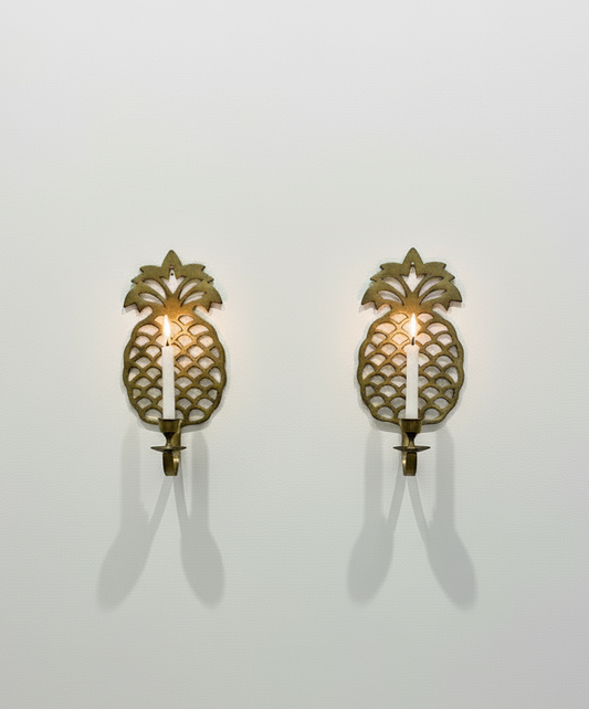 Pair of vintage brass pineapple wall candle sconces with intricate openwork detailing and golden patina, a timeless decorative set symbolising warmth and hospitality — Hommes and Gardens, Wallscape Collection, Smoke + Fire Collection, Home Decor, Landscape Architect, Interior Designer, Outdoor Living, Outdoor Decorations, Home Design, Luxury Design, Art, Furniture, Objects, Best Gifts, Nature, Backyard, Yard.