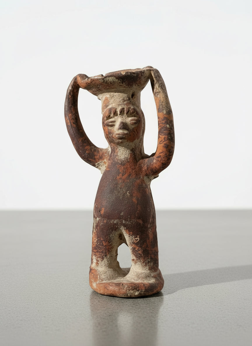 Pre-Columbian style terracotta ritual figure with raised arms and dish atop head, front view showing earthy brown surface and aged texture — Hommes and Gardens, Home Decor, landscape design, plant design, Landscape Architect, Interior Designer, Outdoor Living, Outdoor Decorations, Home Design, Luxury Design, Art, Furniture, Objects, Best Gifts, Nature, Backyard, Yard.