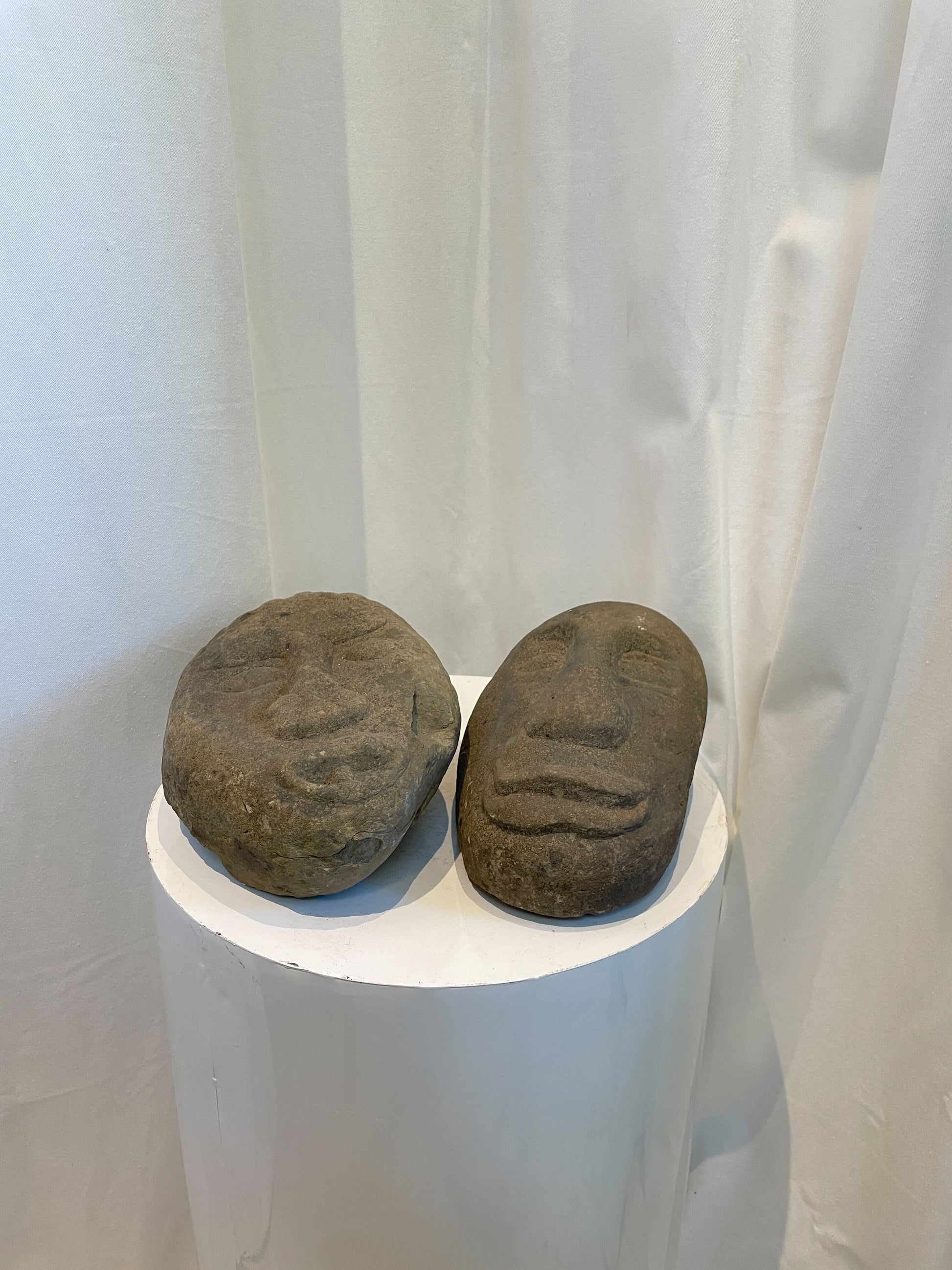 Primitive stone face sculptures handcrafted from natural stone, evoking indigenous art and cultural expression — Hommes and Gardens, home decor, garden decor, outdoor decorations, home design, luxury design, Landscape Architect, Interior Designer, Outdoor Living, Art, Furniture, Objects, Best Gifts, Nature, Backyard, Yard.