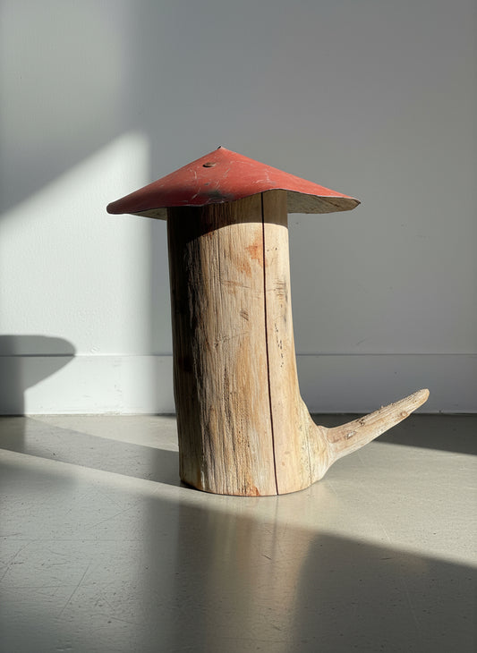 Red-metal-cap mushroom sculpture crafted from a natural log stem with branch detail and aged patina, showcasing rustic handmade folk art and woodland-inspired design — Hommes and Gardens, Home Decor Collection, landscape design, plant design, Landscape Architect, Interior Designer, Outdoor Living, Outdoor Decorations, Home Design, Luxury Design, Art, Furniture, Objects, Best Gifts, Nature, Backyard, Yard.