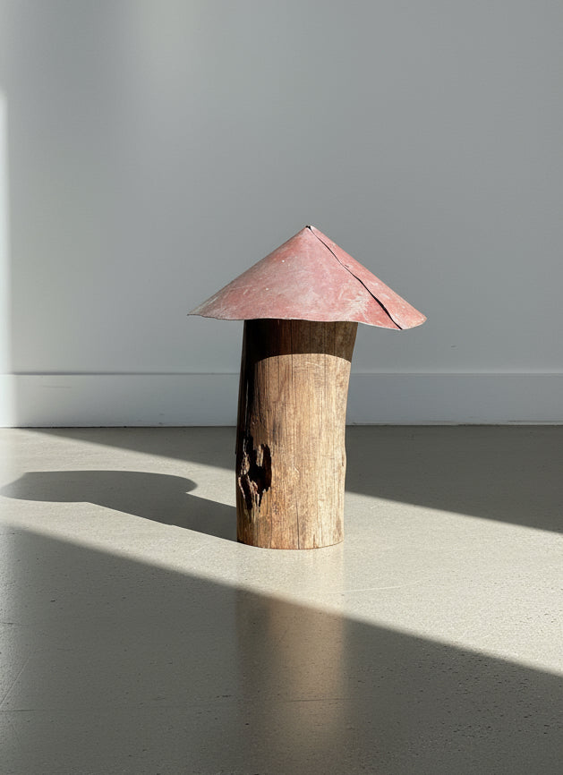 Red-metal-cap mushroom sculpture handcrafted from a weathered log stem with natural wear and patina, showcasing rustic handmade folk art and reclaimed garden design — Hommes and Gardens, Home Decor Collection, landscape design, plant design, Landscape Architect, Interior Designer, Outdoor Living, Outdoor Decorations, Home Design, Luxury Design, Art, Furniture, Objects, Best Gifts, Nature, Backyard, Yard.