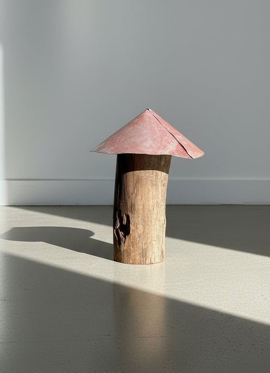 Red-metal-cap mushroom sculpture handcrafted from a weathered log stem with natural wear and patina, showcasing rustic handmade folk art and reclaimed garden design — Hommes and Gardens, Home Decor Collection, landscape design, plant design, Landscape Architect, Interior Designer, Outdoor Living, Outdoor Decorations, Home Design, Luxury Design, Art, Furniture, Objects, Best Gifts, Nature, Backyard, Yard.