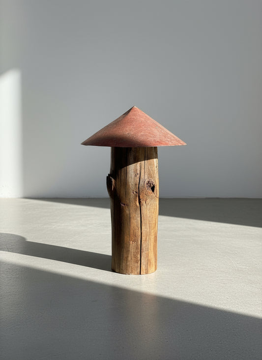 Rounded red-roof mushroom sculpture made from weathered wood with visible knots and cracks, highlighting rustic primitive folk art design and reclaimed craftsmanship — Hommes and Gardens, Home Decor Collection, landscape design, plant design, Landscape Architect, Interior Designer, Outdoor Living, Outdoor Decorations, Home Design, Luxury Design, Art, Furniture, Objects, Best Gifts, Nature, Backyard, Yard.