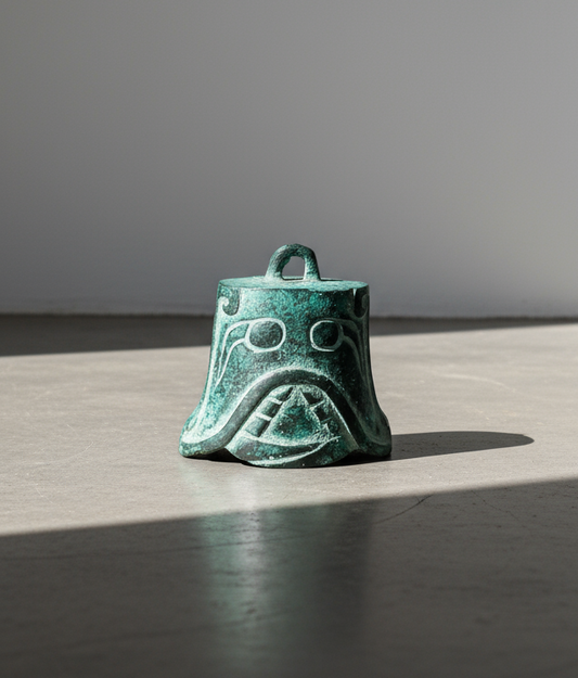 Shang Dynasty bronze bell intricately engraved with mask motifs, symbolising ancient Chinese artistry and ceremonial heritage — Hommes and Gardens, Home Decor Collection, Collectibles, Antiques, Bronze Art, Asian Decor, Cultural Artifact, Historical Piece.