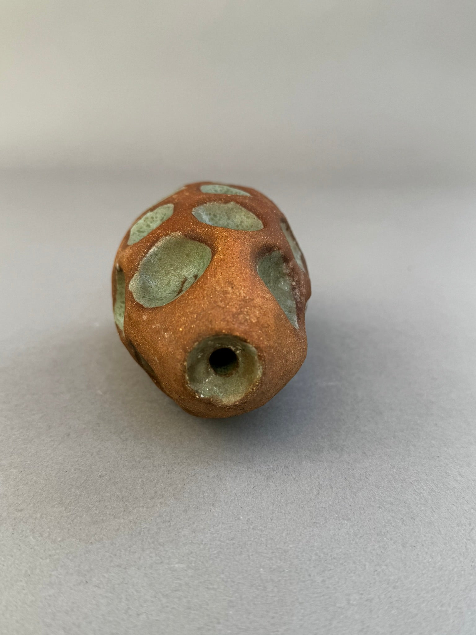 Handcrafted terracotta bud vase with celadon glazed circular impressions and organic sculptural texture, modern studio pottery piece — Hommes and Gardens, Home Decor Collection, landscape design, plant design, Landscape Architect, Interior Designer, Outdoor Living, Outdoor Decorations, Home Design, Luxury Design, Art, Furniture, Objects, Best Gifts, Nature, Backyard, Yard.