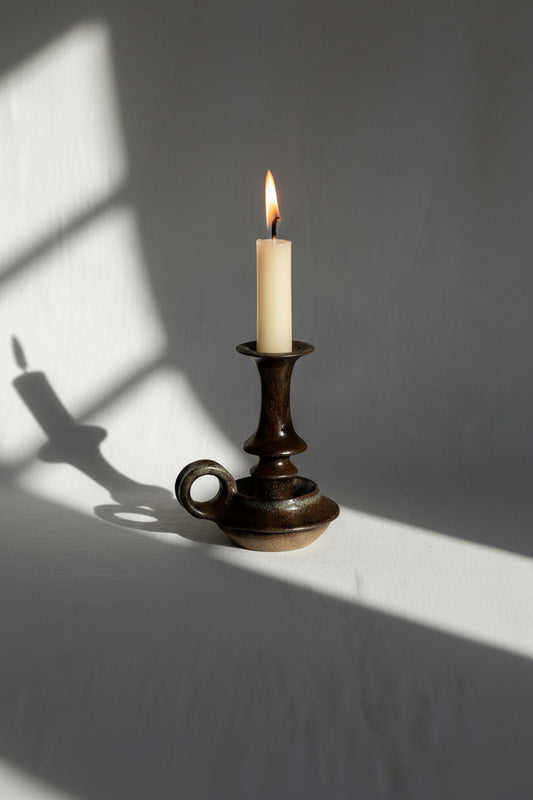 Vintage brown ceramic stoneware candle holder featuring a rich dark glaze and timeless craftsmanship, ideal for warm and elegant interiors — Hommes and Gardens, Home Decor Collection, Candles, Candle Holders, Vintage Pottery, Handmade Decor, Rustic Ceramic Art, Classic Home Accent.