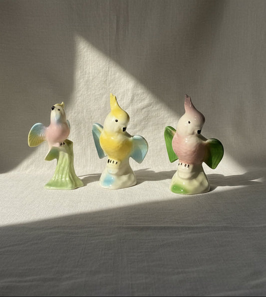 Vintage ceramic cockatoo figures set of three, hand-painted with intricate detailing capturing mid-century charm — Hommes and Gardens, Home Decor Collection, Figurines, Vintage Pottery, Bird Sculptures, Handcrafted Ceramic Art, Mid-Century Decor, Collectible Animal Figurines.