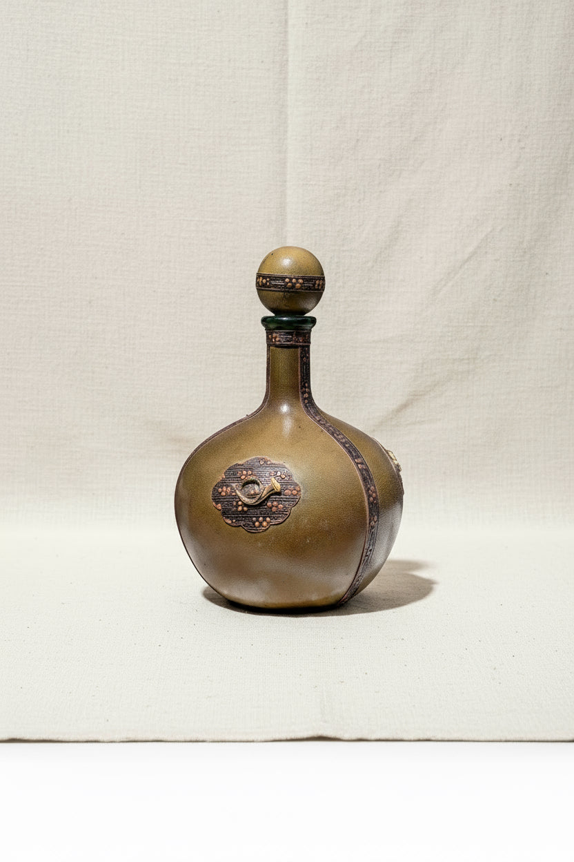 Vintage Italian green leather-wrapped decanter with a musical horn emblem, elegant collectible for classic bar decor — Hommes and Gardens, Home Decor Collection, Decanters, Vintage Barware, Italian Leather Art, Decorative Objects, Retro Drinkware, Gift for Collectors.