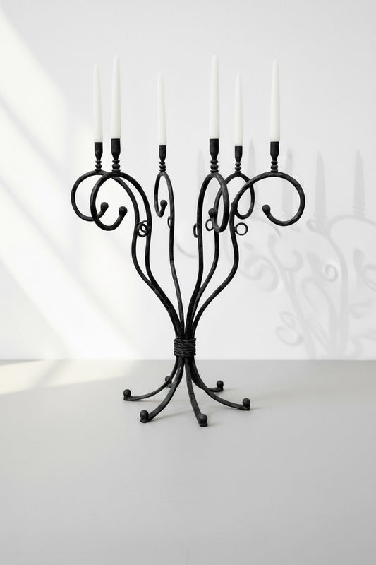 Vintage scrolled cast iron candelabrum with six arms and elegant French-inspired design, a striking antique centerpiece exuding timeless charm — Hommes and Gardens, Candles Collection, Candle Holders, Decorative Objects, Vintage Ironwork, Classic Home Decor, Antique Lighting Accent, Rustic Elegance, Old World Design.