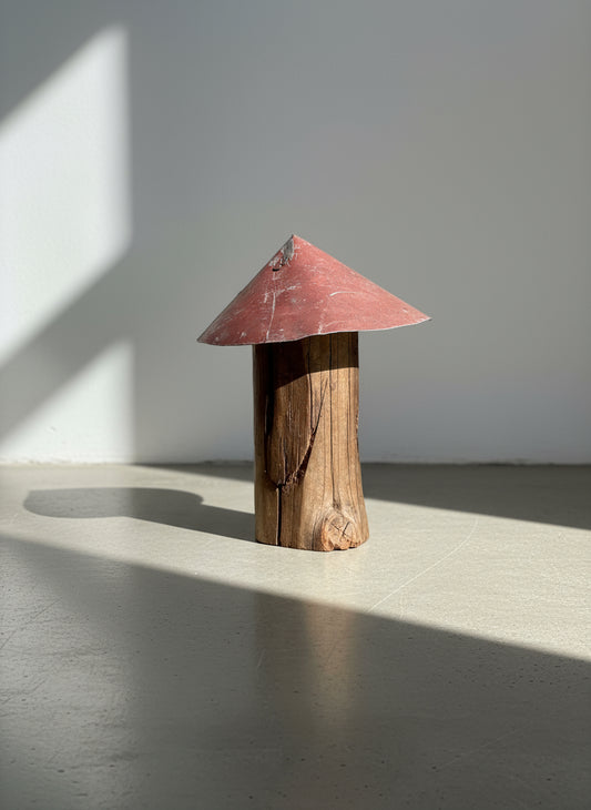 Weathered red-roof mushroom sculpture handcrafted from aged wood with visible cracks and knots, showcasing rustic primitive folk art design and reclaimed craftsmanship — Hommes and Gardens, Home Decor Collection, landscape design, plant design, Landscape Architect, Interior Designer, Outdoor Living, Outdoor Decorations, Home Design, Luxury Design, Art, Furniture, Objects, Best Gifts, Nature, Backyard, Yard.