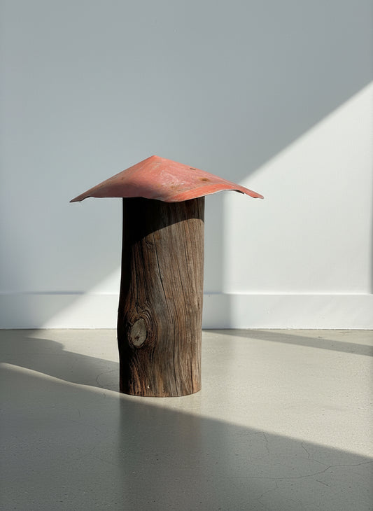 Wide-roof mushroom sculpture handcrafted from weathered wood with a broad red metal top, showcasing rustic primitive folk art and reclaimed design — Hommes and Gardens, Home Decor Collection, landscape design, plant design, Landscape Architect, Interior Designer, Outdoor Living, Outdoor Decorations, Home Design, Luxury Design, Art, Furniture, Objects, Best Gifts, Nature, Backyard, Yard