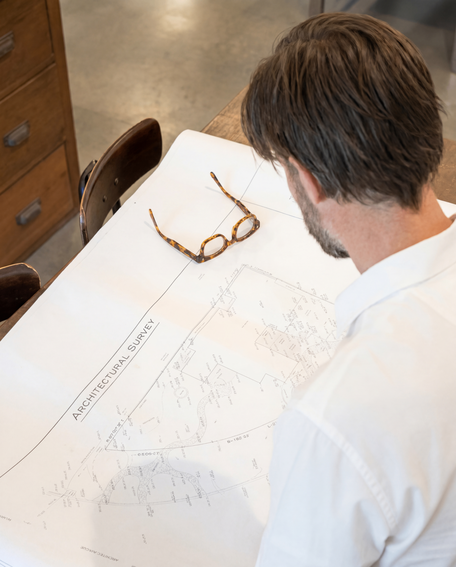 Landscape plans spread across a work table in the studio, Los Angeles landscape design by Hommes + Gardens