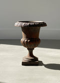 Antique French Neoclassical Cast Iron Mini Urn Planter – Aged Patina, showcasing a fluted tulip shape and rust patina, hommes + gardens estudio.