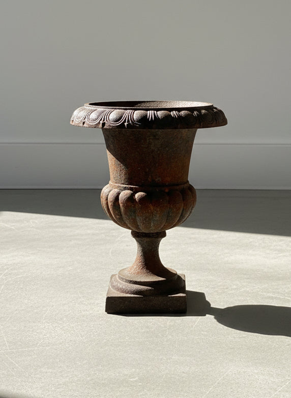Antique French Neoclassical Cast Iron Mini Urn Planter – Aged Patina, showcasing a fluted tulip shape and rust patina, hommes + gardens estudio.