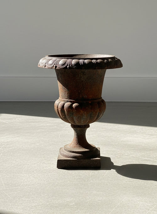 Antique French Neoclassical Cast Iron Mini Urn Planter – Aged Patina, showcasing a fluted tulip shape and rust patina, hommes + gardens estudio.