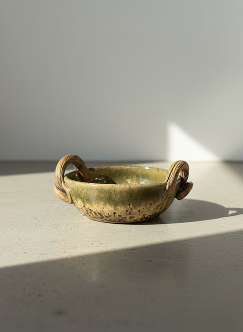 artisan studio pottery bowl with vine handles and earth tone glaze