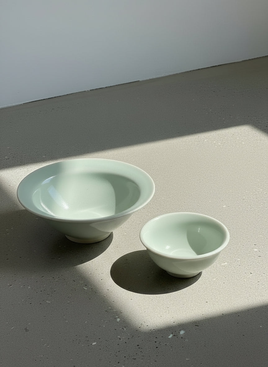 Elegant handcrafted celadon glazed ceramic bowl set by Paula, signed and dated 2003, featuring one large and one small bowls in soft green tones — Hommes and Gardens, Catchall Collection, Landscape Architect, Interior Designer, Outdoor Living, Art, Furniture, Objects, Best Gifts, Nature, Backyard, Yard, Outdoor Decorations, Home Decor, Home Design, Luxury Design.