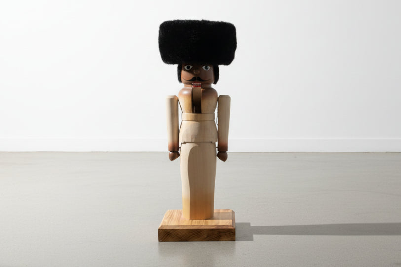 Hand-Carved Wooden Nutcracker Figure with Fur Hat, Sculptural Folk Art Form, Late 20th Century