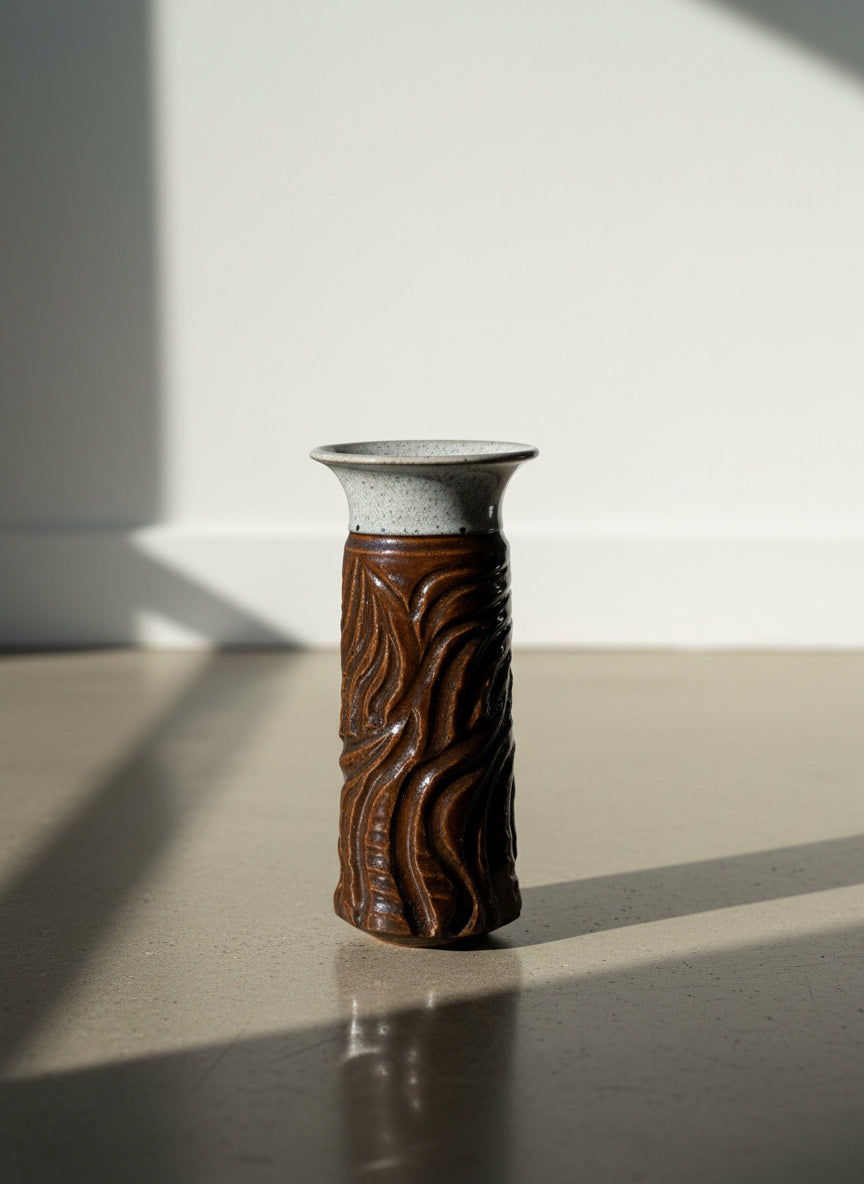Ceramic vase with textured design on a neutral background
