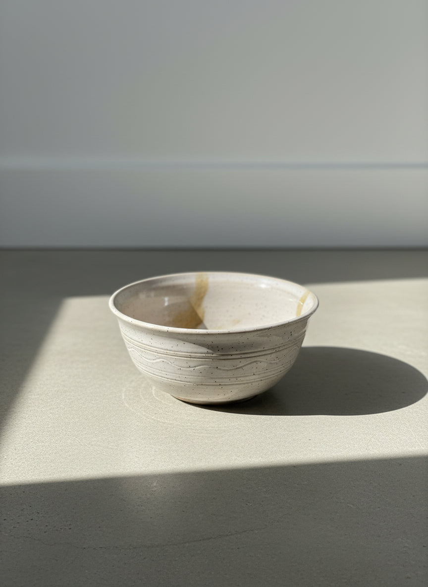 handcrafted speckled stoneware bowl with drip glaze detail