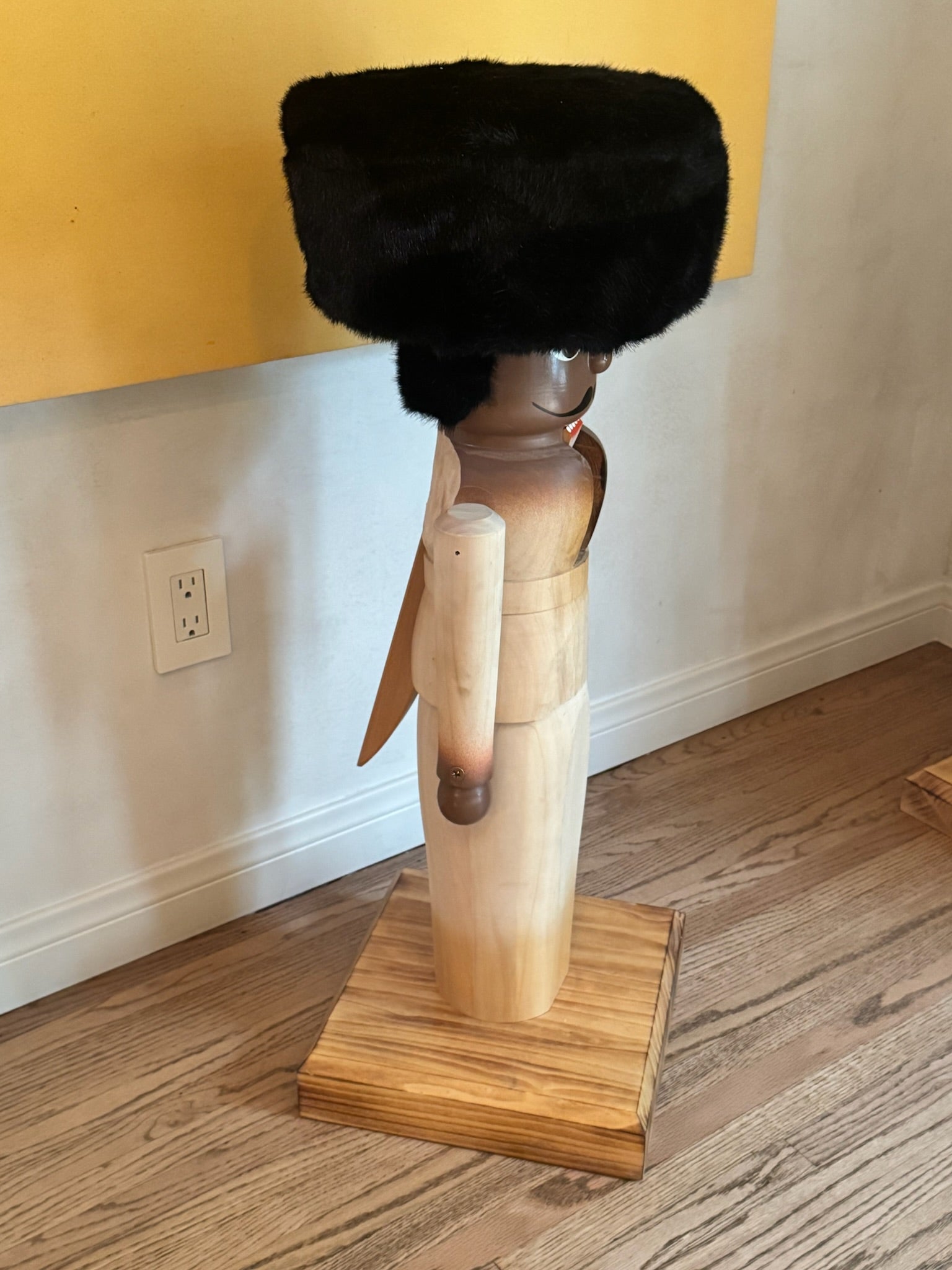 Hand-Carved Wooden Nutcracker Figure with Fur Hat, Sculptural Folk Art Form, Late 20th Century
