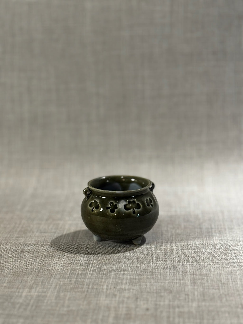 tripod ceramic bowl with pierced shamrock pattern