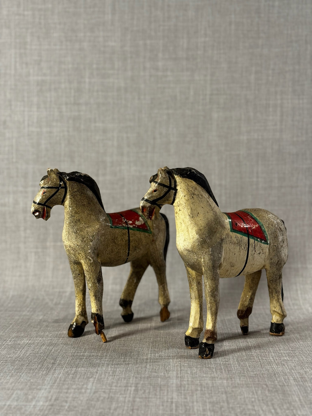Pair of Vintage Hand-Carved Wooden Folk Art Horses with Aged Painted Saddles