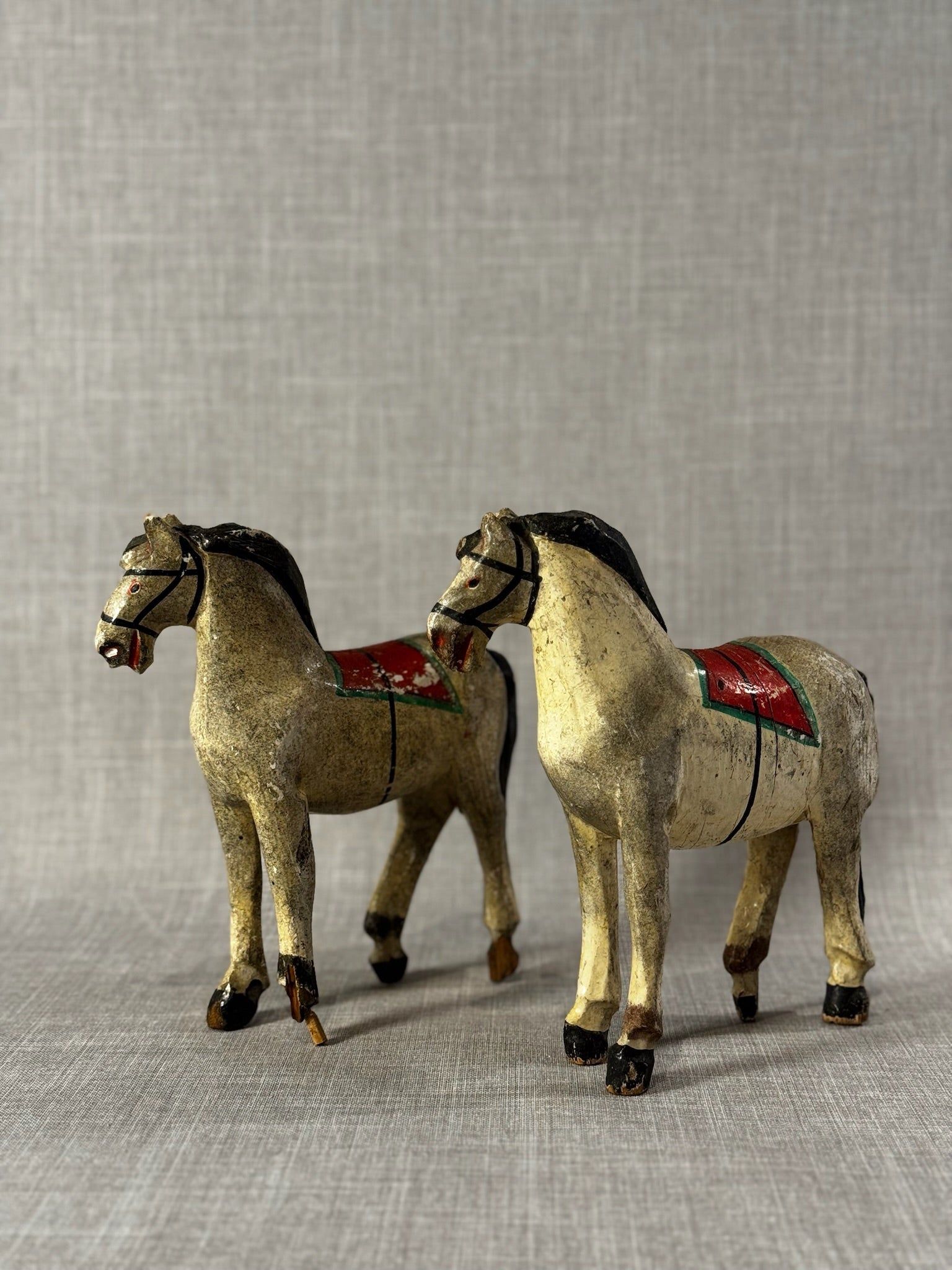 Pair of Vintage Hand-Carved Wooden Folk Art Horses with Aged Painted Saddles