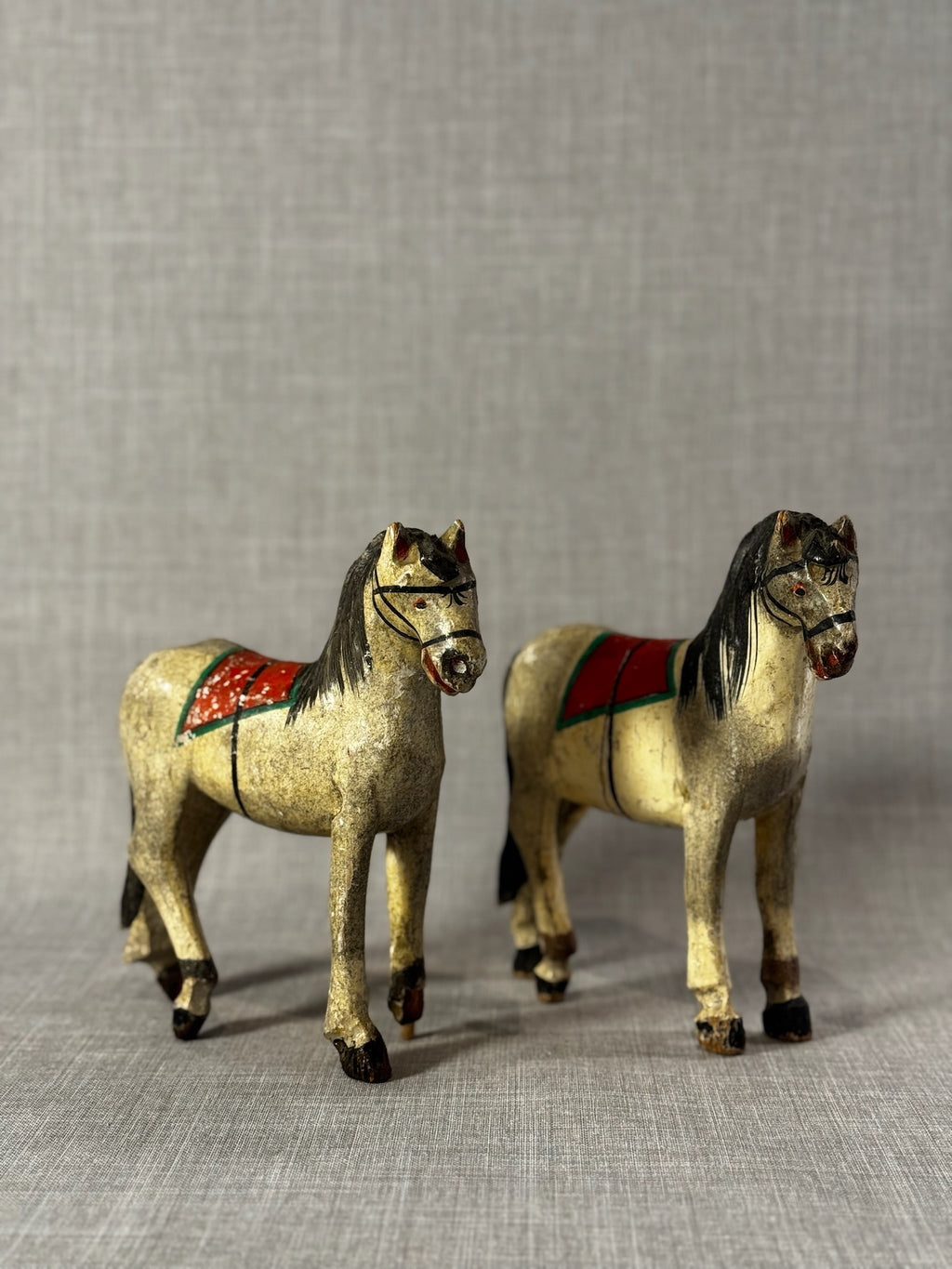 Pair of Vintage Hand-Carved Wooden Folk Art Horses with Aged Painted Saddles