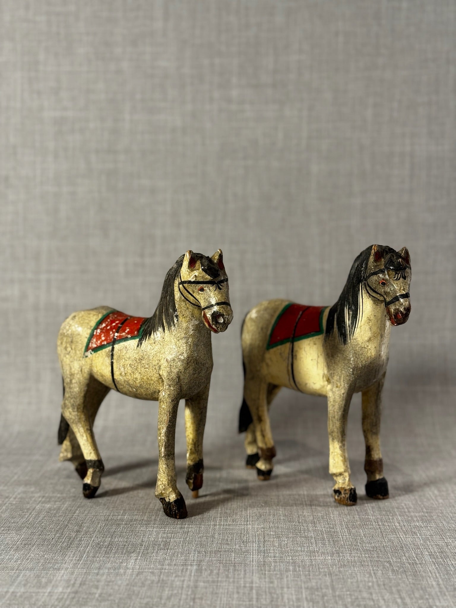 Pair of Vintage Hand-Carved Wooden Folk Art Horses with Aged Painted Saddles