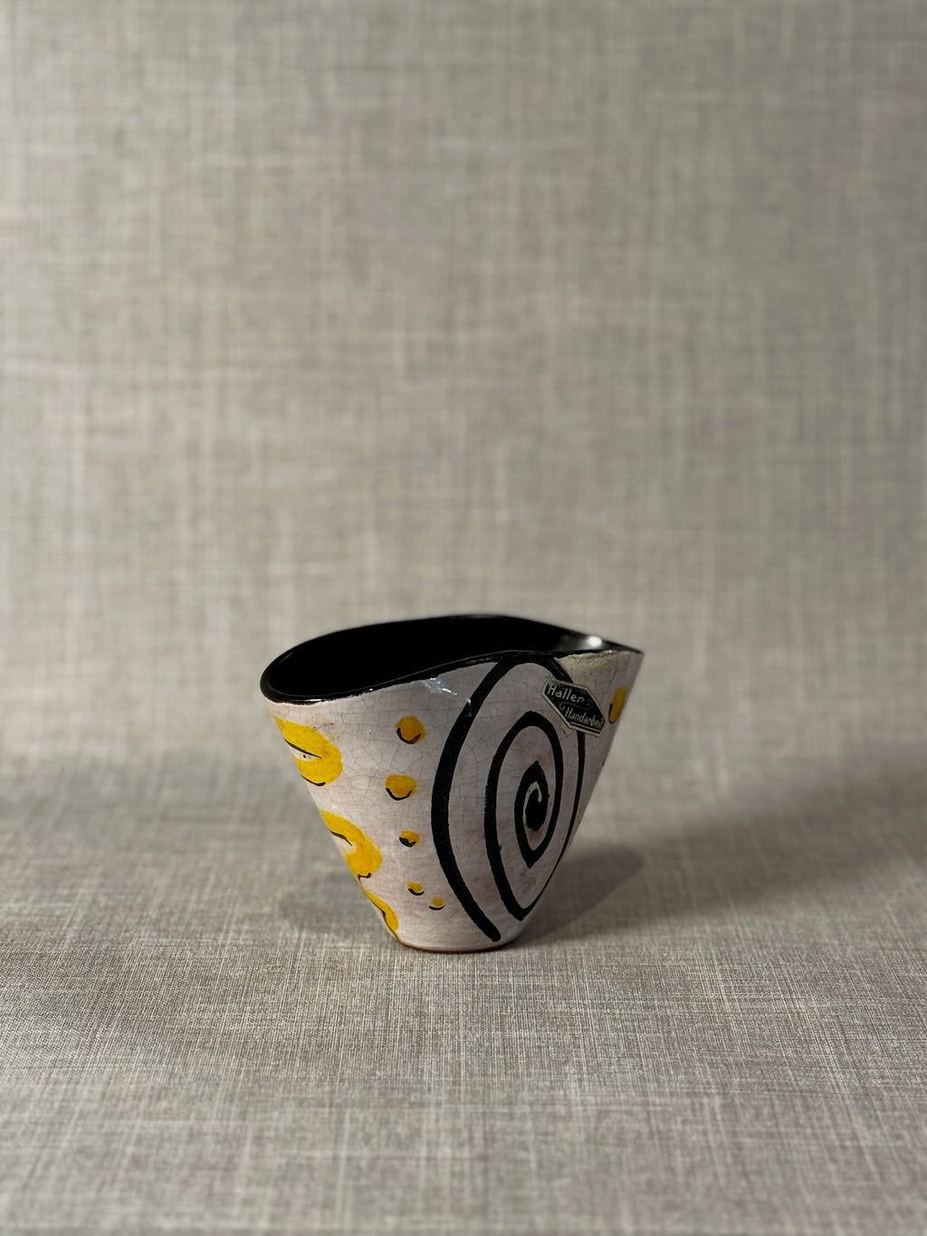 modern sculptural ceramic bowl with yellow accents and crackle glaze