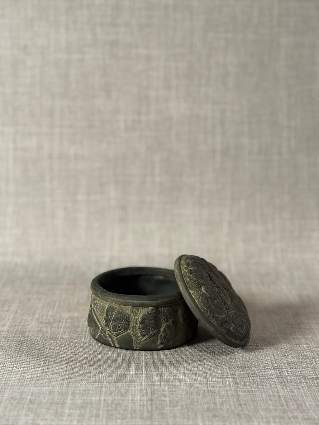 Hand-Carved Dark Grey Terracotta Lidded Vessel with Tribal Portrait Reliefs & Horse Motif