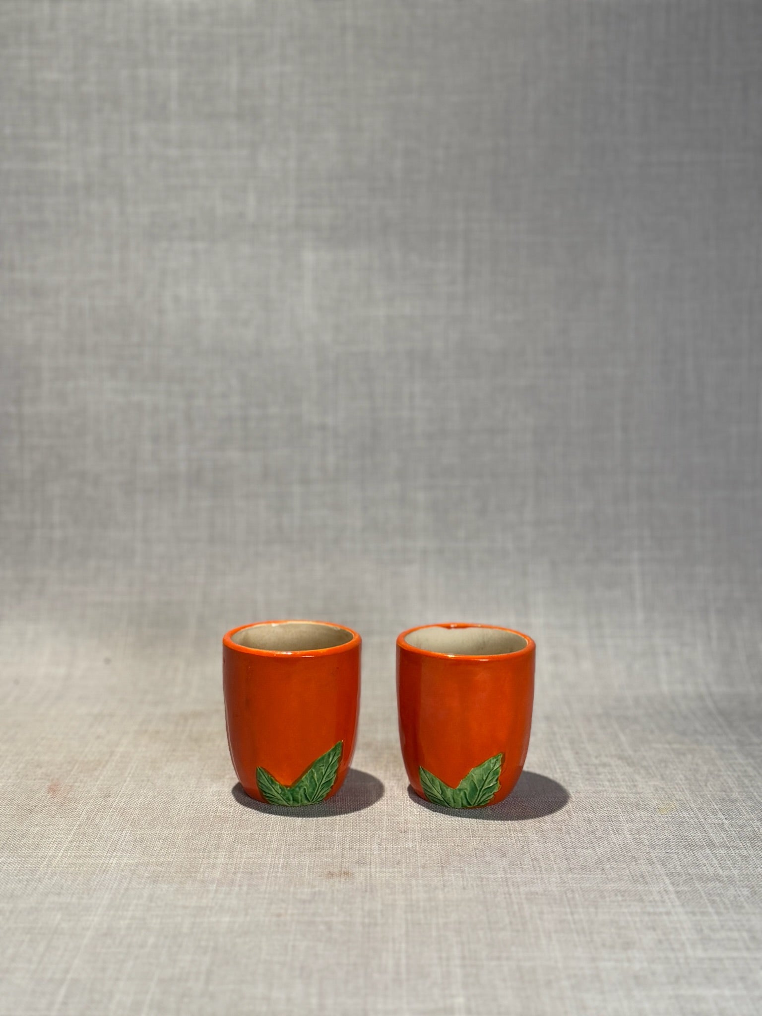 Vintage Japanese Orange Ceramic Mini Cups with Raised Green Leaf Accents – Set of 2