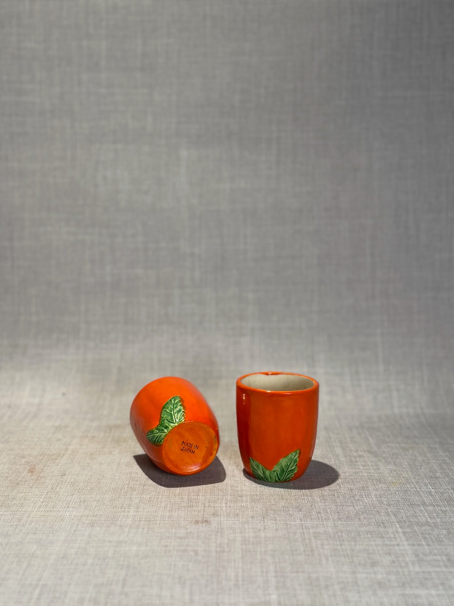 Vintage Japanese Orange Ceramic Mini Cups with Raised Green Leaf Accents – Set of 2