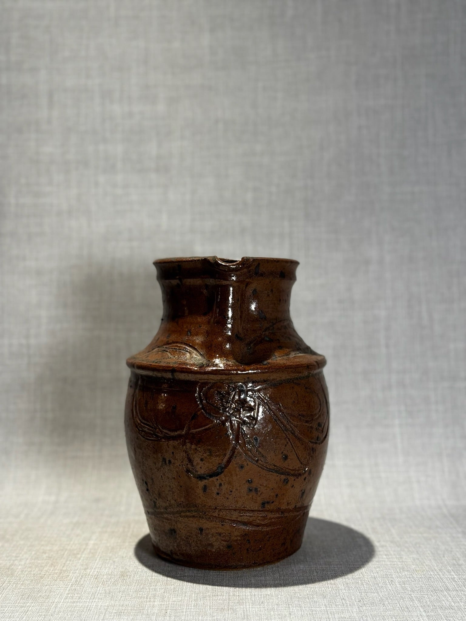 Handmade Rustic Brown Glazed Stoneware Pitcher with Carved Folk Art Motifs