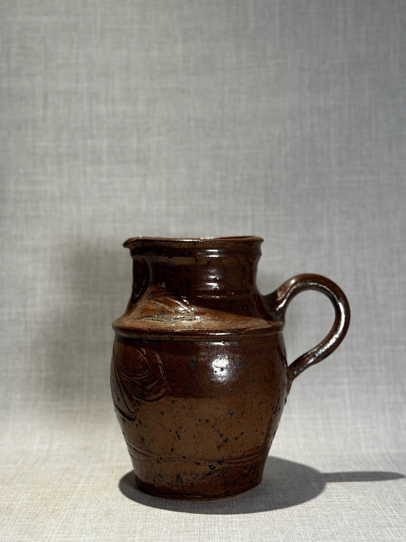 Handmade Rustic Brown Glazed Stoneware Pitcher with Carved Folk Art Motifs